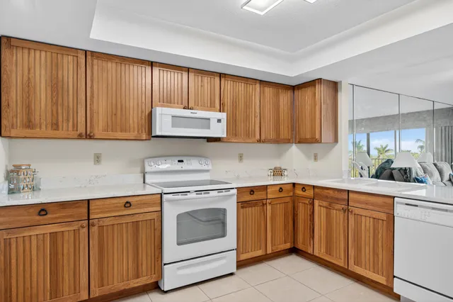 a kitchen with cabinets appliances a sink and a counter space