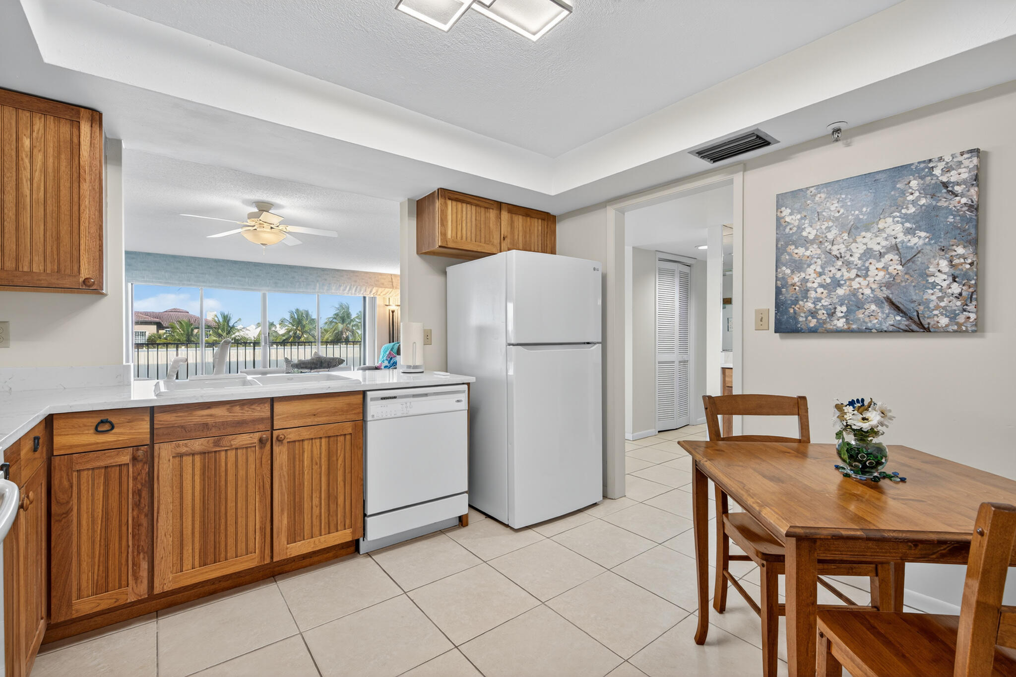 801 South Ocean Drive, Unit 404 Fort Pierce, FL 34949 - Photo 20 of 37 a kitchen with stainless steel appliances a refrigerator a sink a stove a dining table and chairs