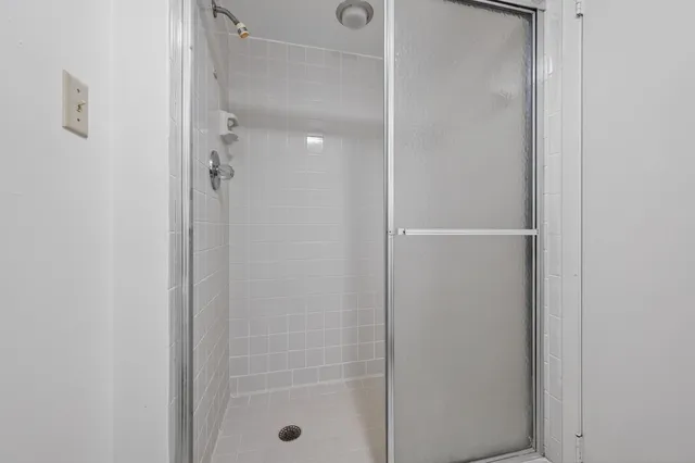 a bathroom with a glass shower door