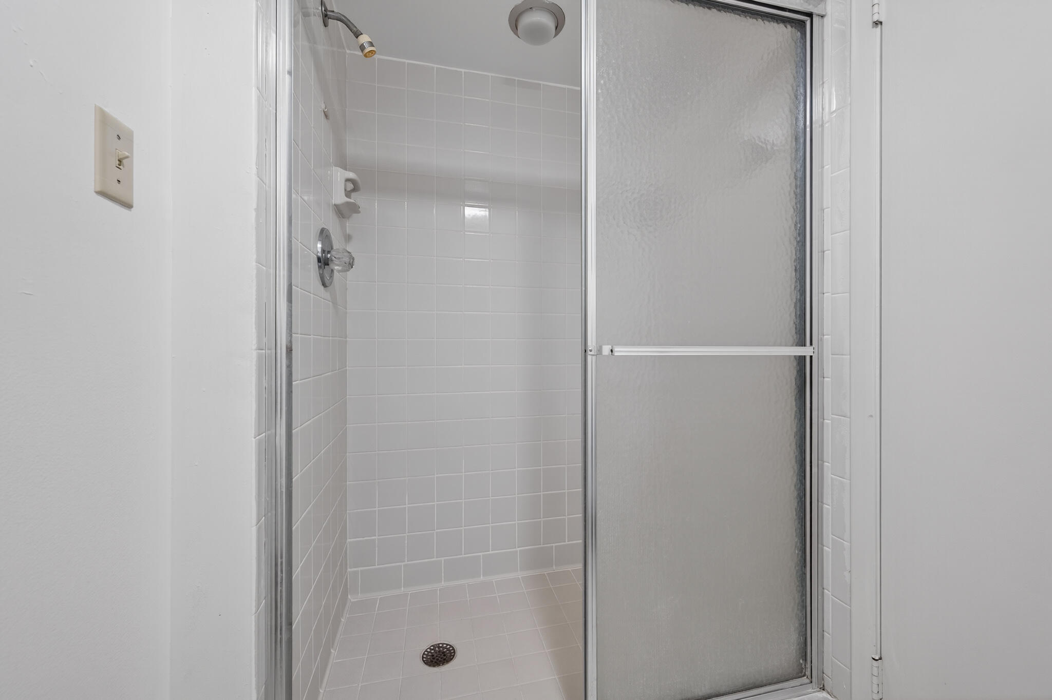 801 South Ocean Drive, Unit 404 Fort Pierce, FL 34949 - Photo 24 of 37 a bathroom with a glass shower door