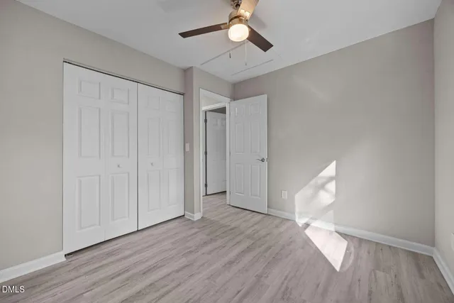 a view of empty room with wooden floor