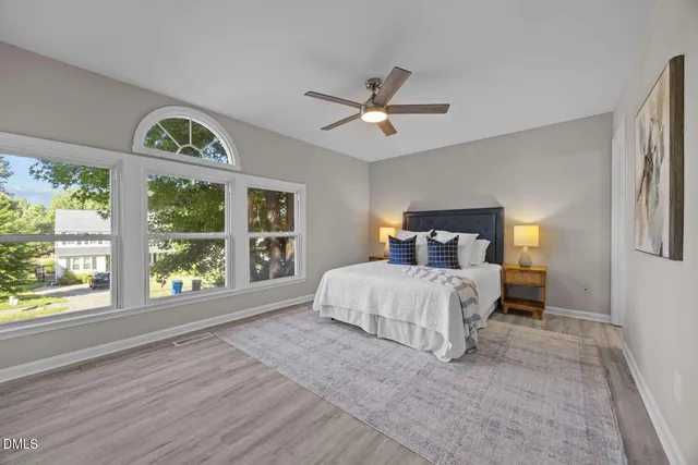 a bedroom with a large bed and a window