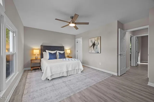 a bedroom with a bed and a chandelier