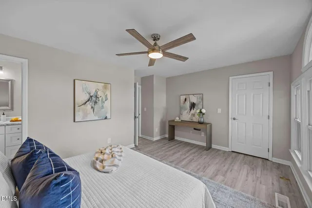 a bedroom with a bed and wooden floor