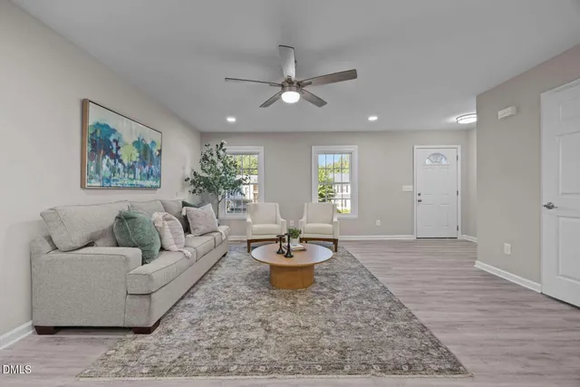 a living room with furniture and a potted plant