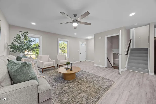 a living room with furniture and wooden floor