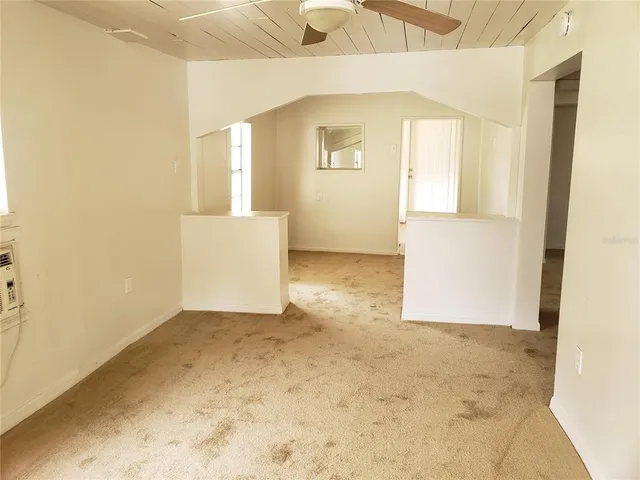 en empty room with windows and entrance