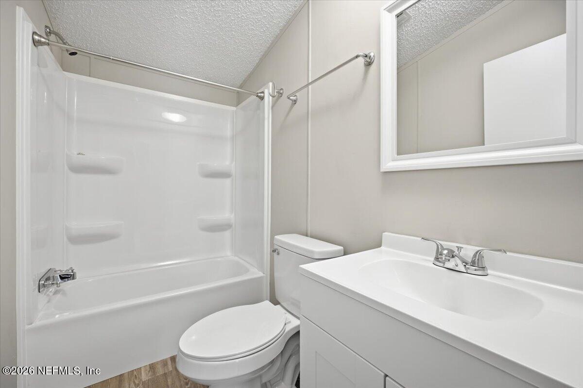 5621 Willow Road Macclenny, FL 32063 - Photo 12 of 15 a bathroom with a sink toilet and shower