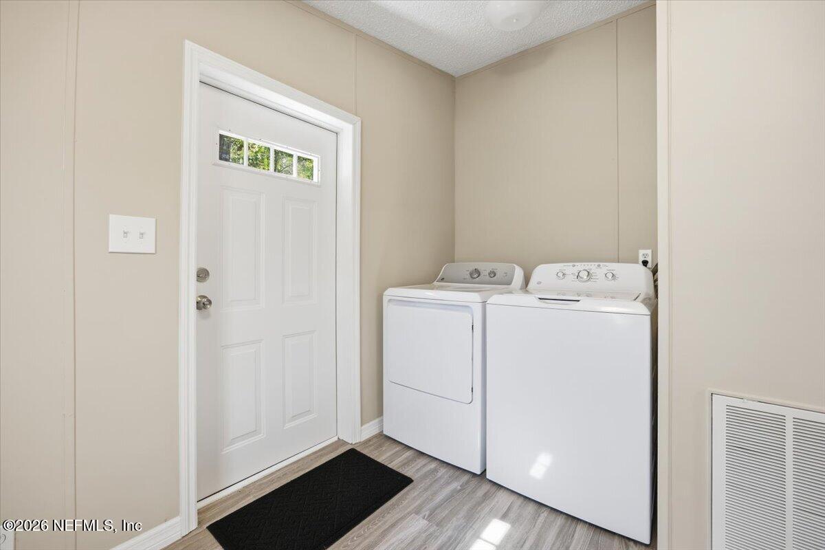 5621 Willow Road Macclenny, FL 32063 - Photo 14 of 15 a utility room with dryer and washer