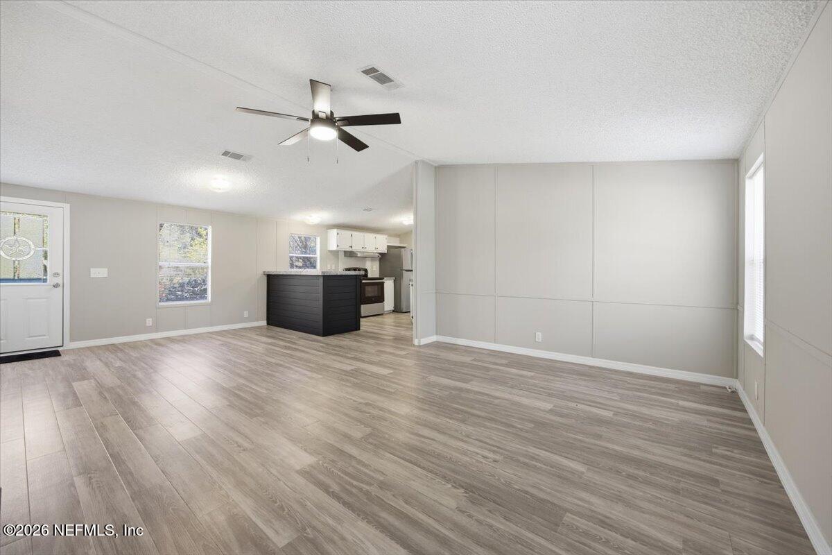 5621 Willow Road Macclenny, FL 32063 - Photo 4 of 15 a view of an empty room with a window and wooden floor