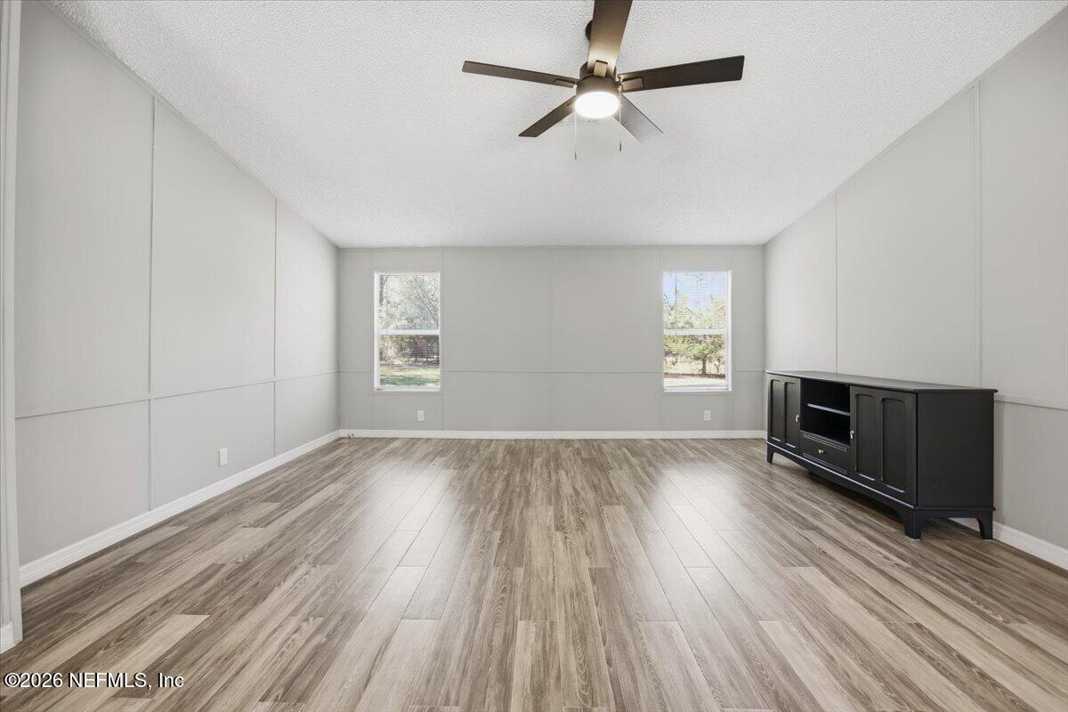 5621 Willow Road Macclenny, FL 32063 - Photo 7 of 15 wooden floor in an empty room with a window