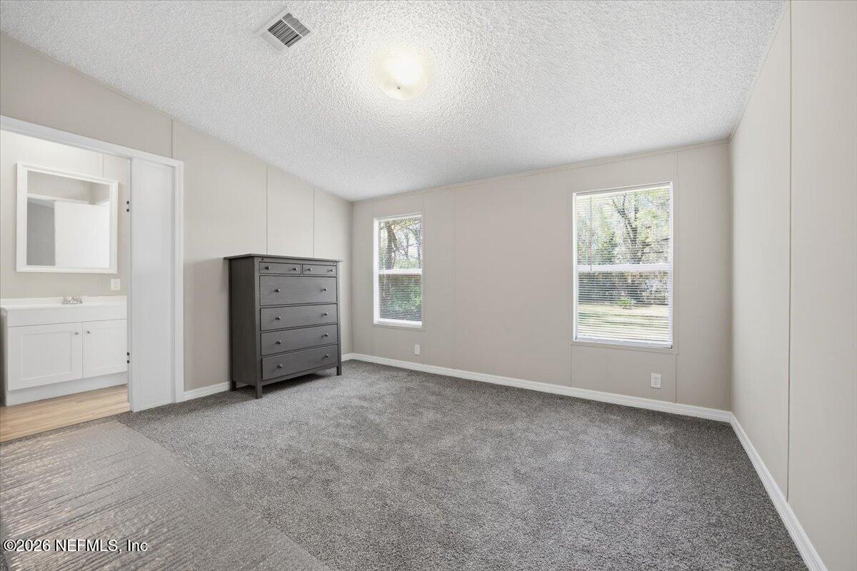 5621 Willow Road Macclenny, FL 32063 - Photo 8 of 15 an empty room with windows and closet
