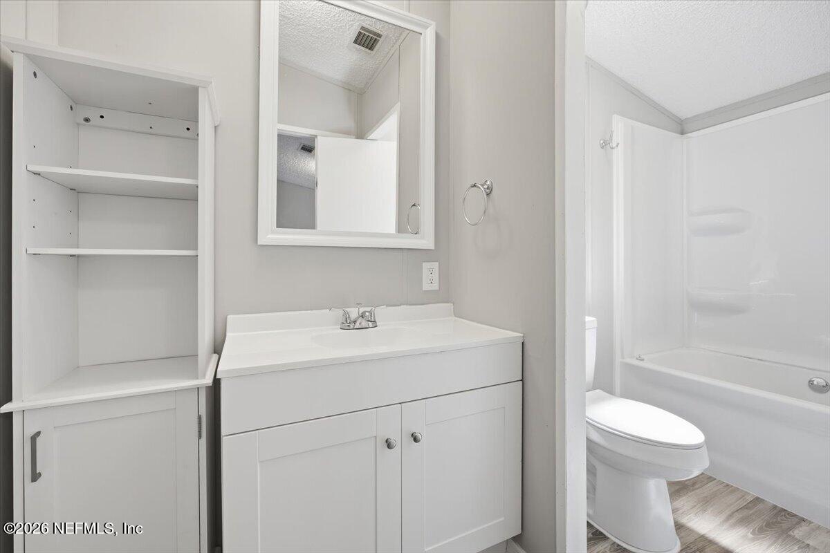 5621 Willow Road Macclenny, FL 32063 - Photo 9 of 15 a bathroom with a sink toilet vanity and shower