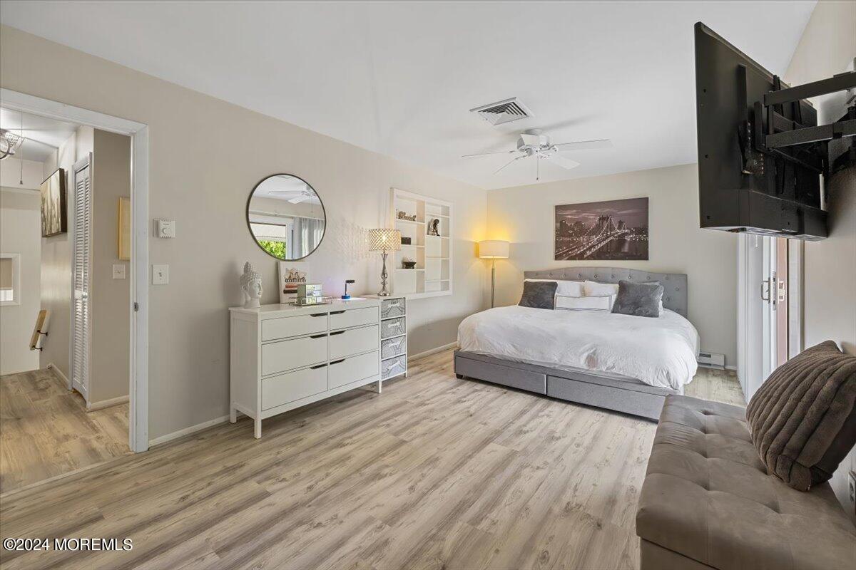 58 Overlook Drive Clinton, NJ 08809 - Photo 16 of 24 a bedroom with a bed a mirror and dresser