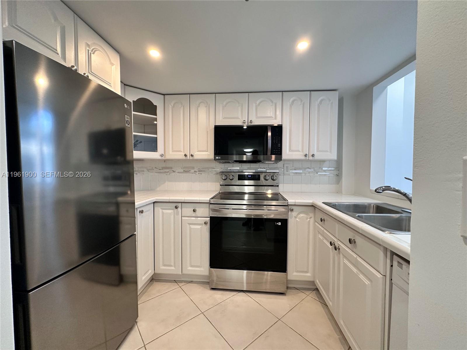540 Brickell Key Drive, Unit 302 Miami, FL 33131 - Photo 1 of 24 a kitchen with stainless steel appliances granite countertop a stove a refrigerator and a sink