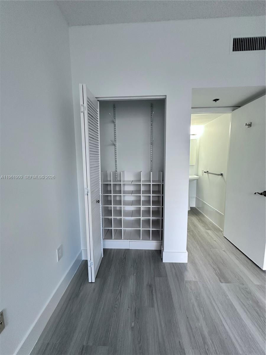 540 Brickell Key Drive, Unit 302 Miami, FL 33131 - Photo 14 of 24 wooden floor and cabinet in a room
