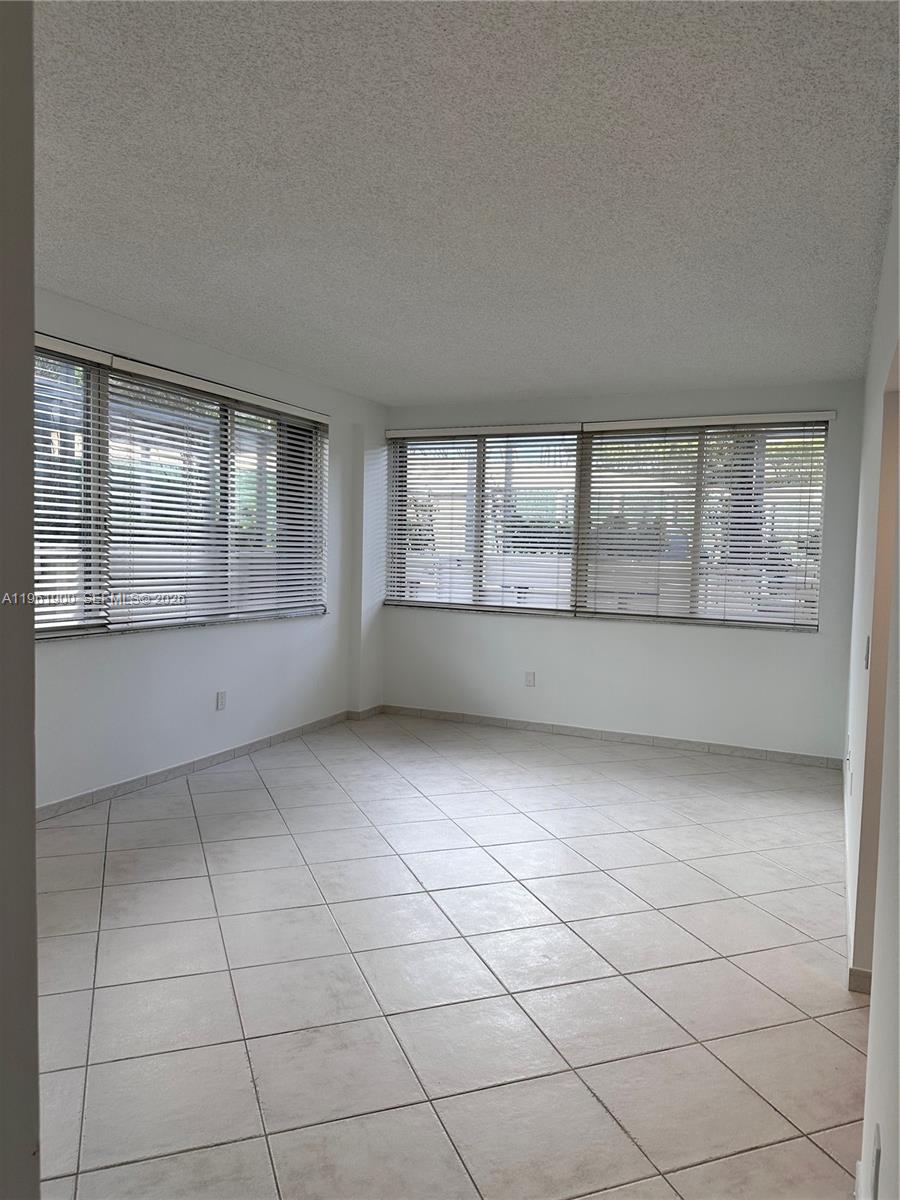 540 Brickell Key Drive, Unit 302 Miami, FL 33131 - Photo 5 of 24 an empty room with windows