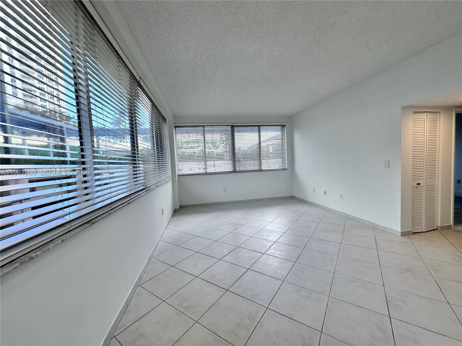 540 Brickell Key Drive, Unit 302 Miami, FL 33131 - Photo 6 of 24 an empty room with windows