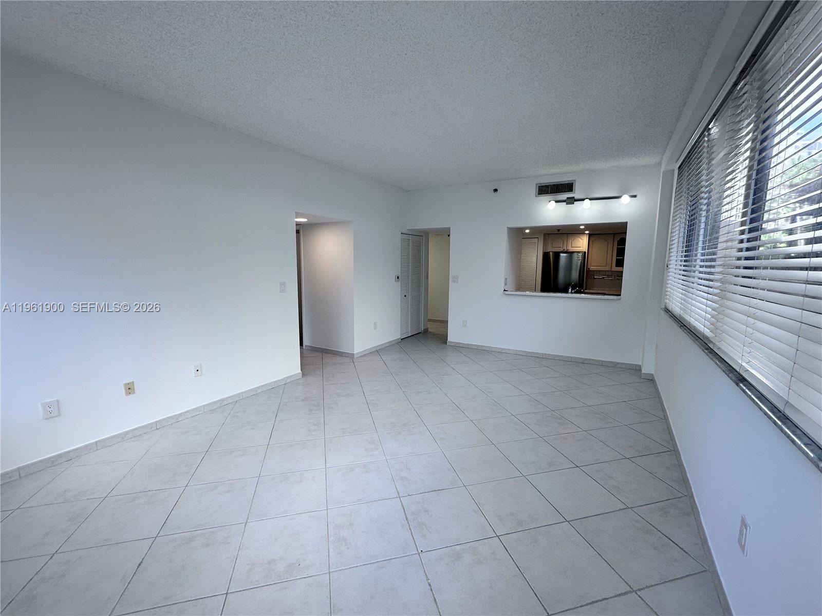 540 Brickell Key Drive, Unit 302 Miami, FL 33131 - Photo 8 of 24 an empty room with a empty space and windows