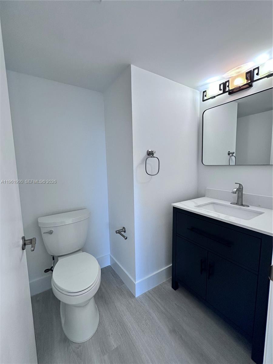 540 Brickell Key Drive, Unit 302 Miami, FL 33131 - Photo 9 of 24 a bathroom with a toilet sink and mirror