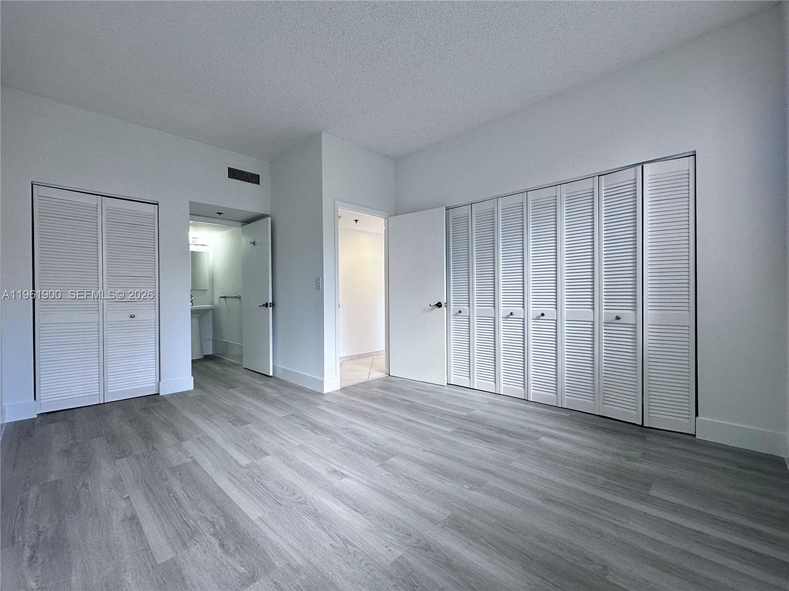 540 Brickell Key Drive, Unit 302 Miami, FL 33131 - Photo 10 of 24 a view of an empty room with wooden floor
