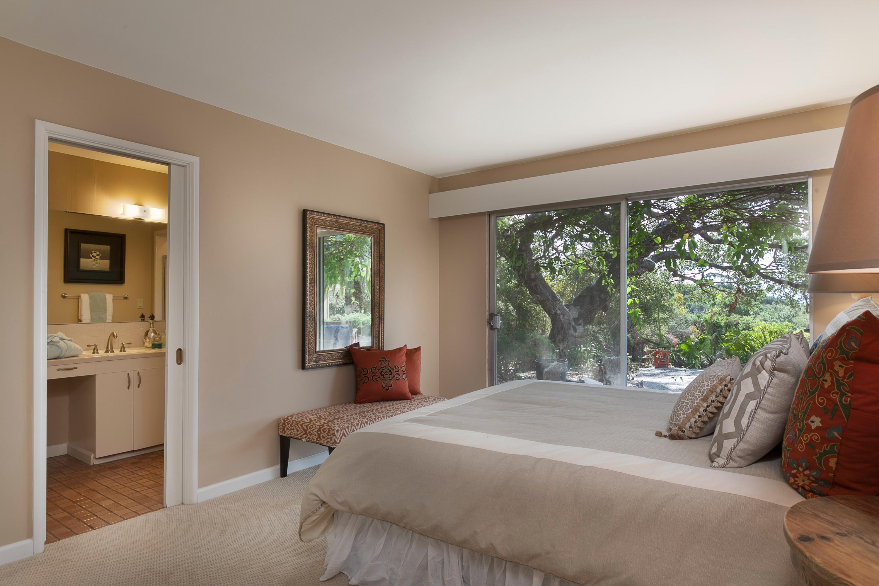 306 Alston Road Montecito, CA 93108 - Photo 9 of 17 a bedroom with a bed and large windows