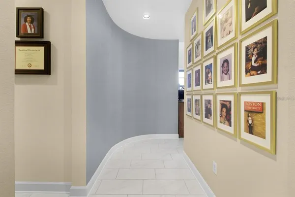 a living room with furniture kitchen view and a wooden floor