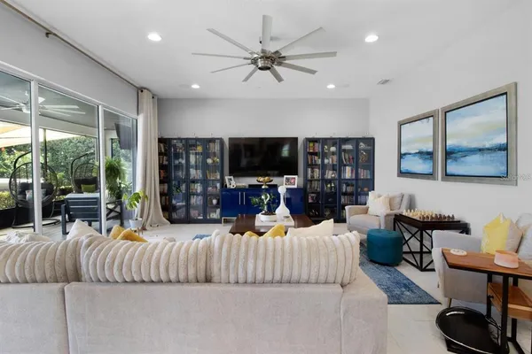 a kitchen with stainless steel appliances kitchen island granite countertop a table chairs sink and cabinets