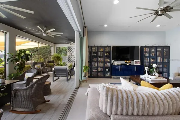 a kitchen with stainless steel appliances granite countertop a table chairs sink refrigerator and microwave