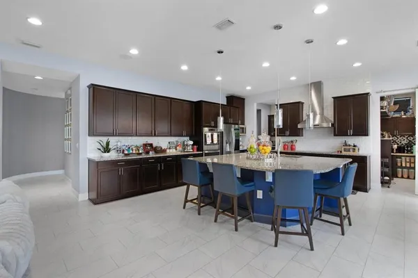 a kitchen with stainless steel appliances granite countertop a sink a stove and a refrigerator