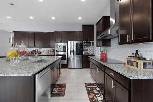 a kitchen with stainless steel appliances granite countertop a sink and cabinets