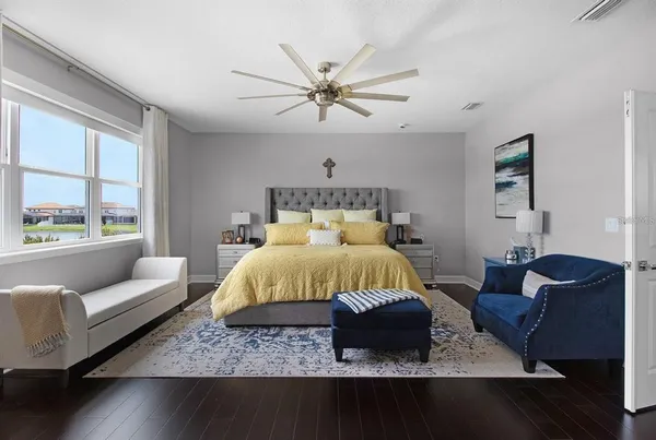 a bedroom with a large bed and a window