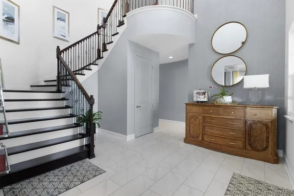 a view of entryway bedroom and hall with wooden floor