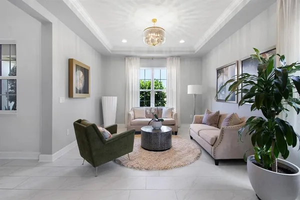 a living room with furniture potted plant and a window