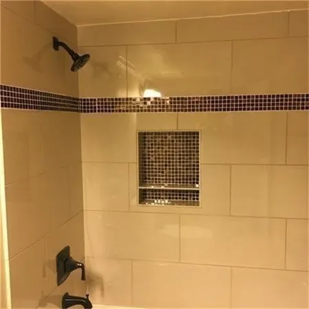 a bathroom with a granite countertop sink a toilet and shower