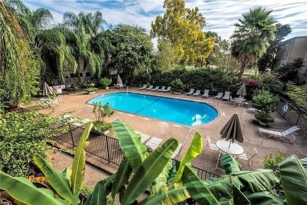 a view of a patio with table and chairs and potted plants