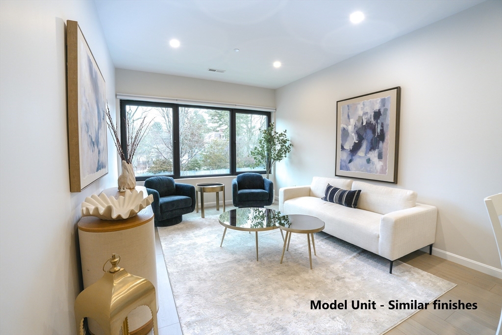 680 Worcester Street, Unit 104 Wellesley, MA 02482 - Photo 1 of 19 a living room with furniture and a large window