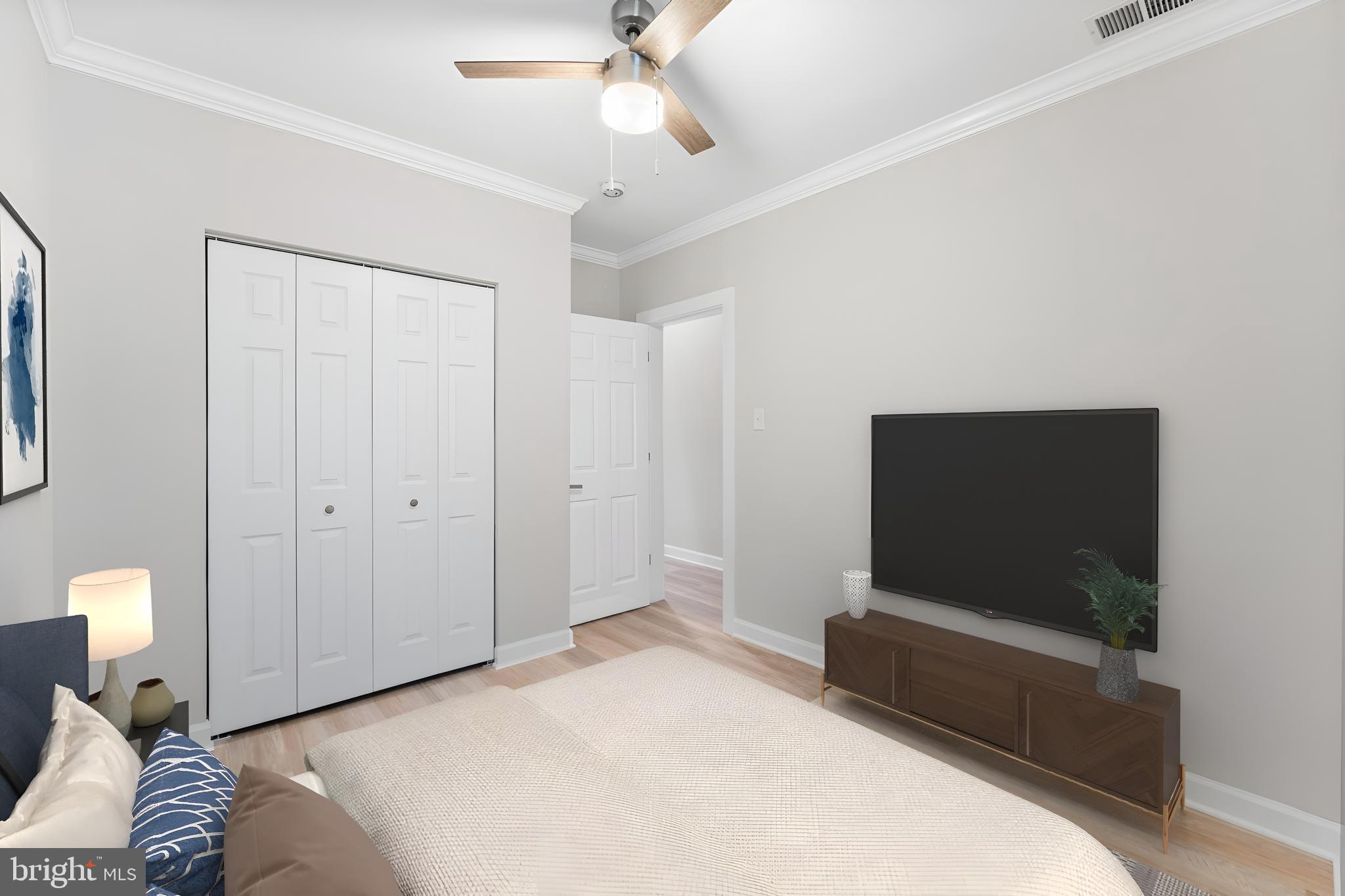 1003 West Fayette Street Baltimore, MD 21223 - Photo 19 of 59 a bedroom with a bed and a flat screen tv