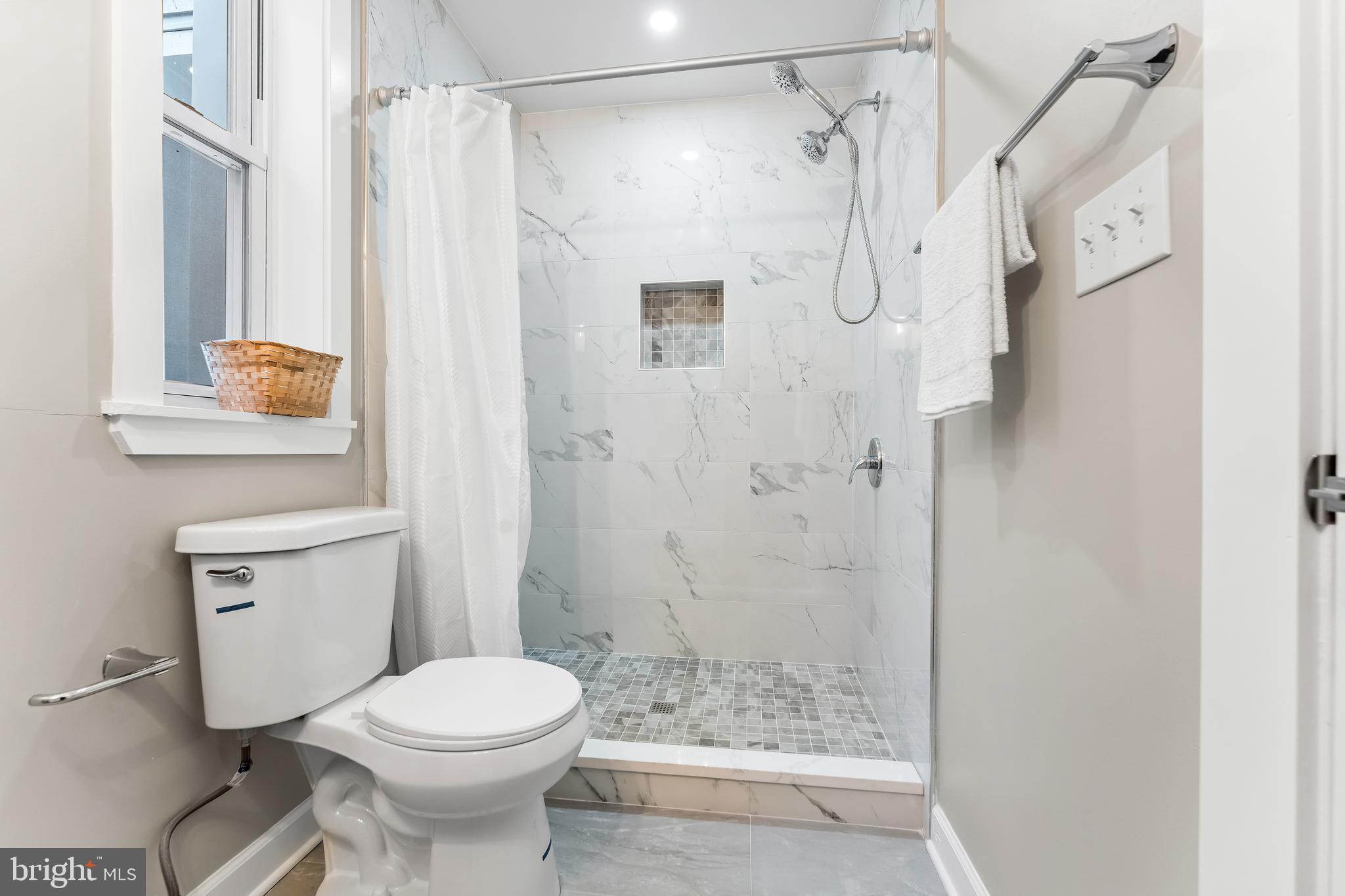 1003 West Fayette Street Baltimore, MD 21223 - Photo 25 of 59 a bathroom with a shower toilet and sink