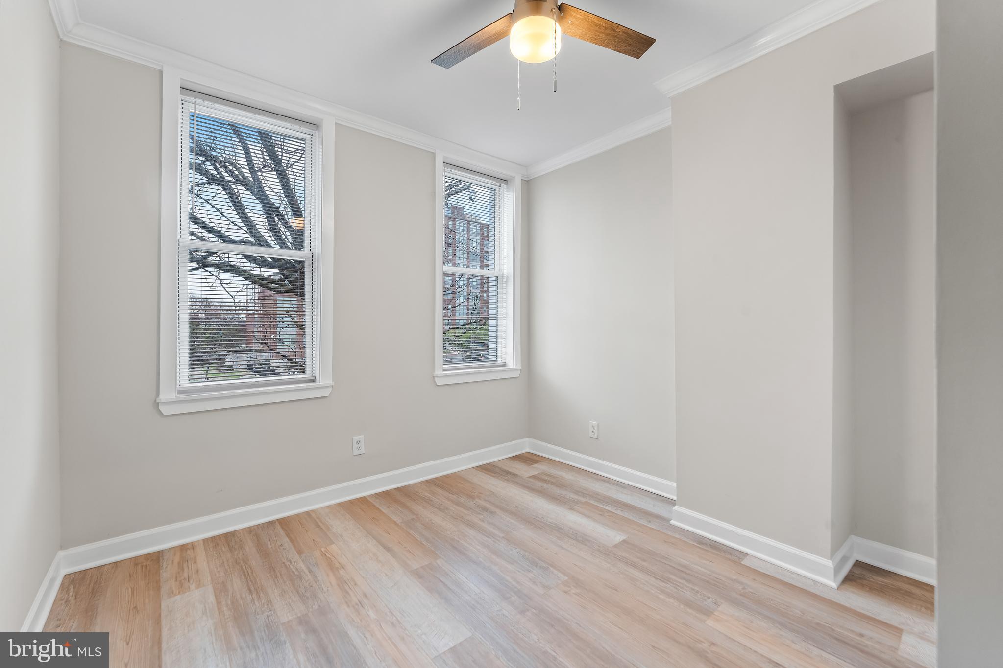 1003 West Fayette Street Baltimore, MD 21223 - Photo 27 of 59 a view of an empty room with wooden floor and a window