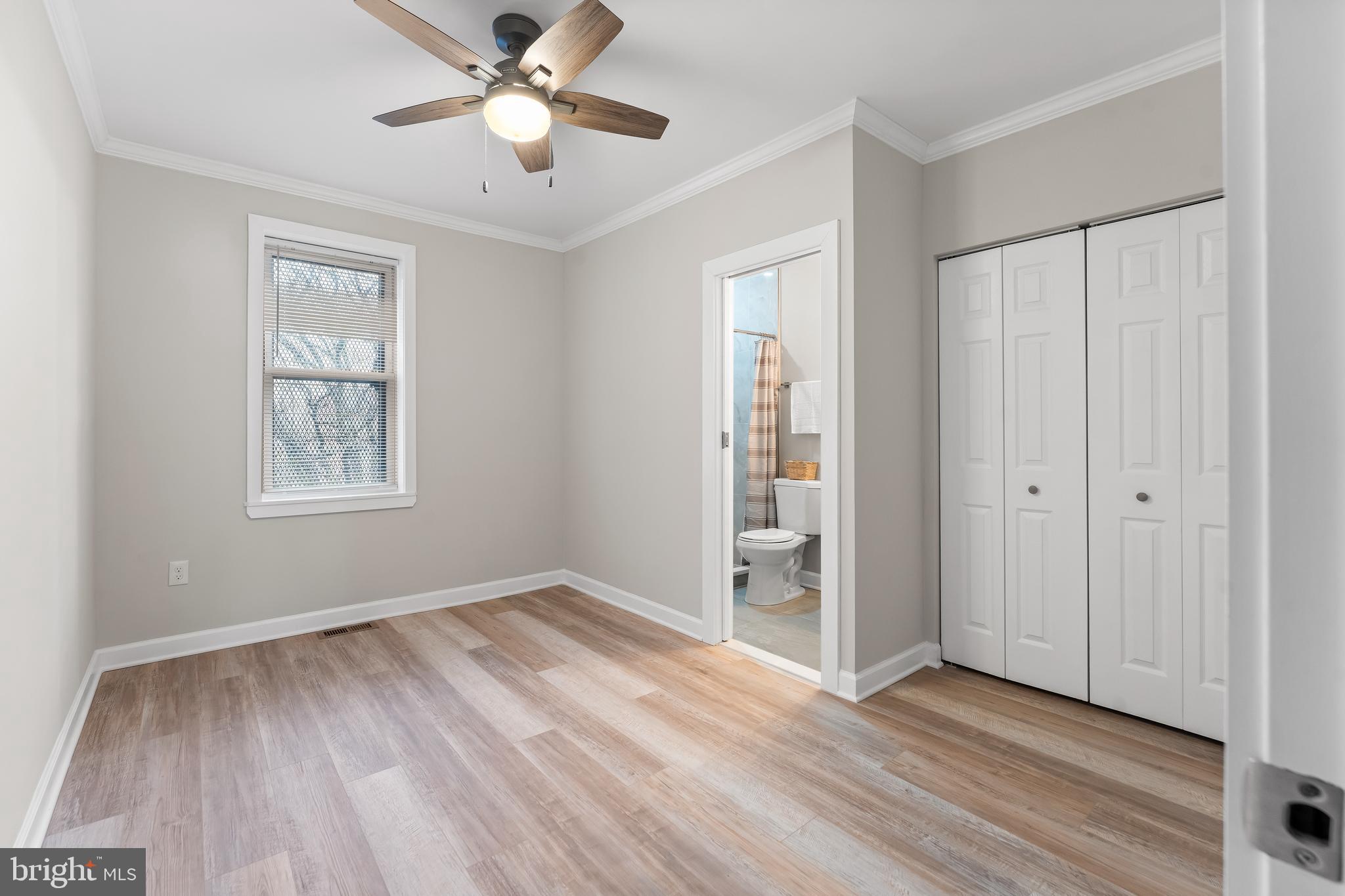 1003 West Fayette Street Baltimore, MD 21223 - Photo 31 of 59 a view of an empty room with window and wooden floor