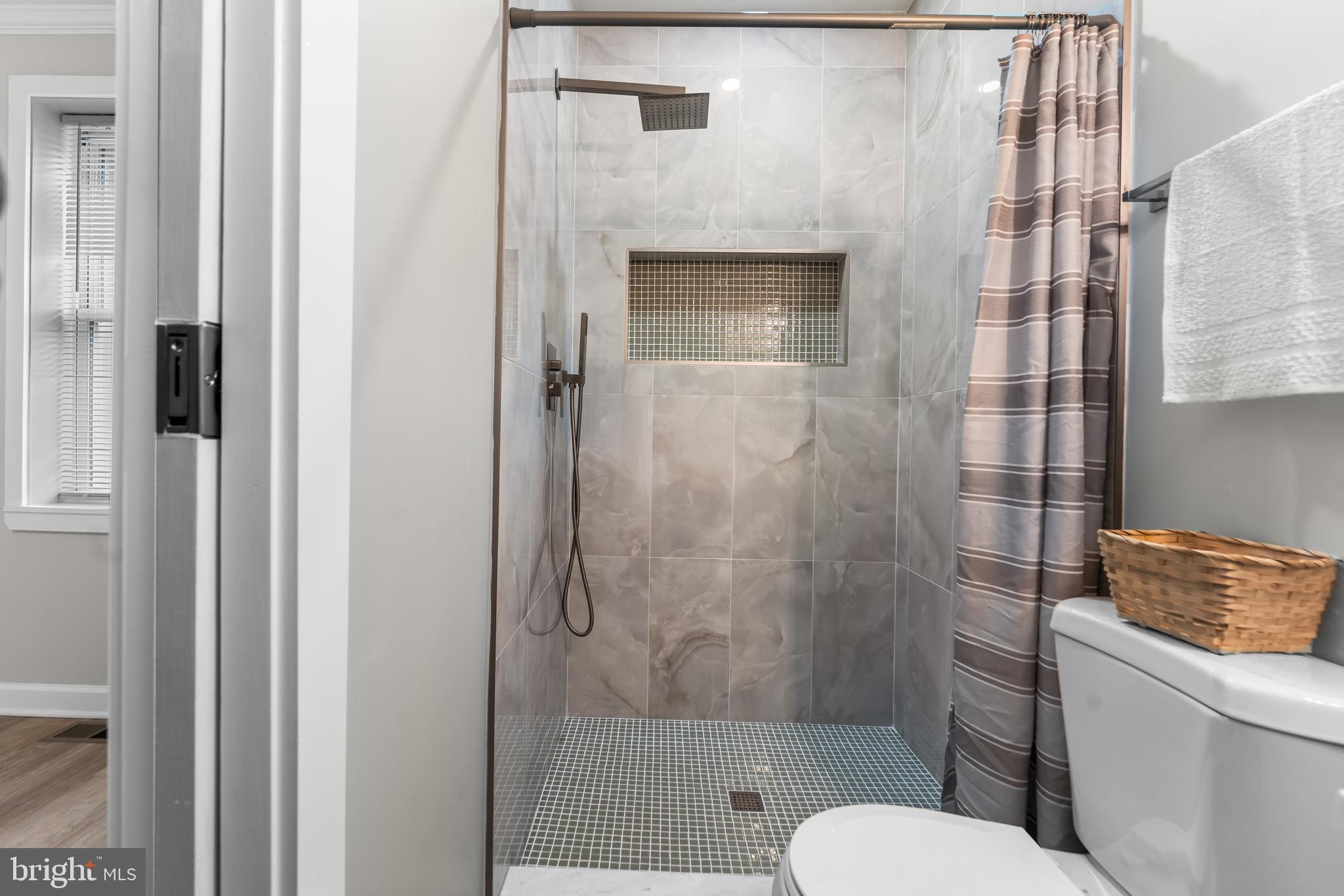 1003 West Fayette Street Baltimore, MD 21223 - Photo 44 of 59 a bathroom with a toilet and a shower