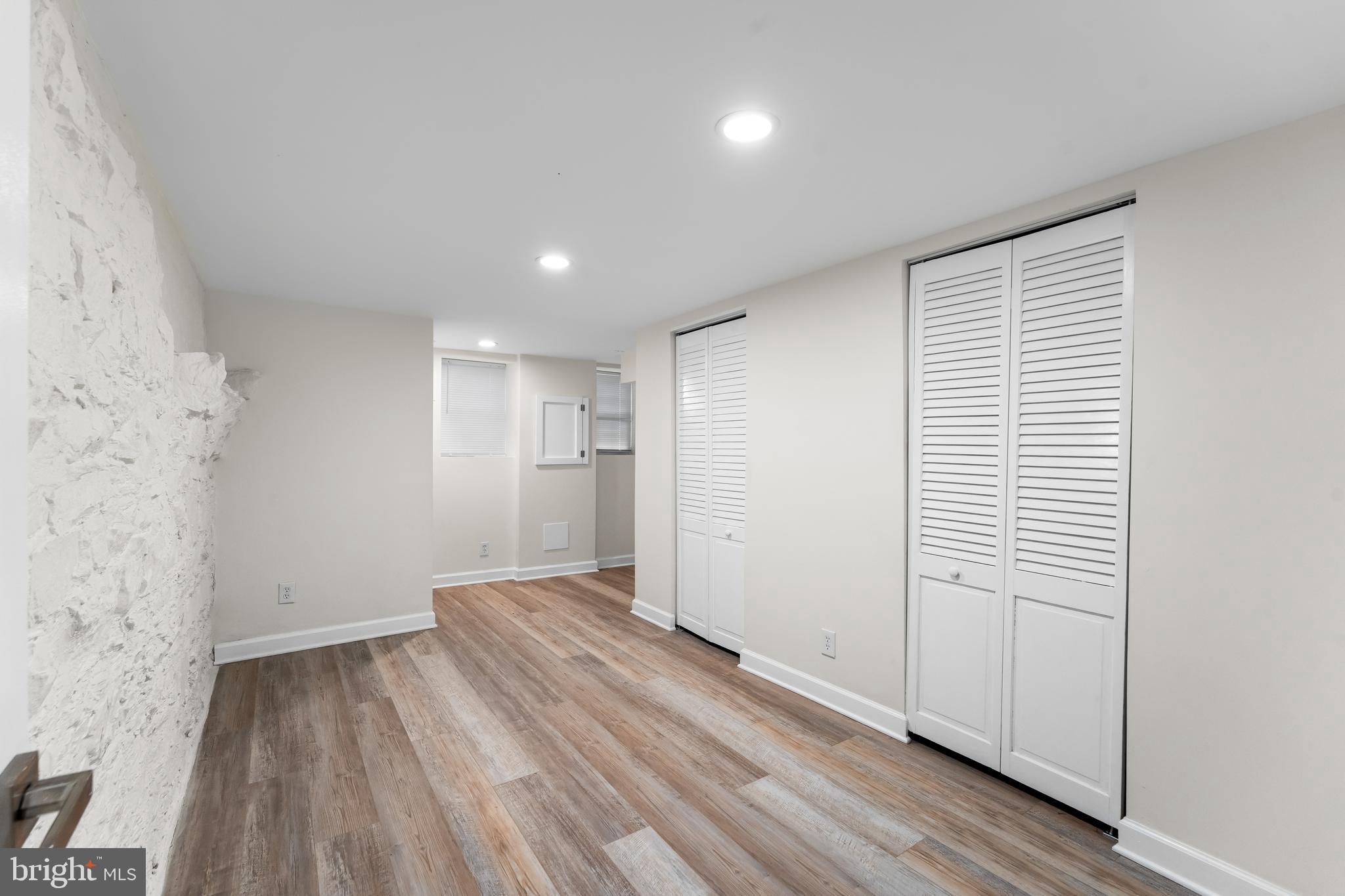 1003 West Fayette Street Baltimore, MD 21223 - Photo 52 of 59 an empty room with wooden floor and windows