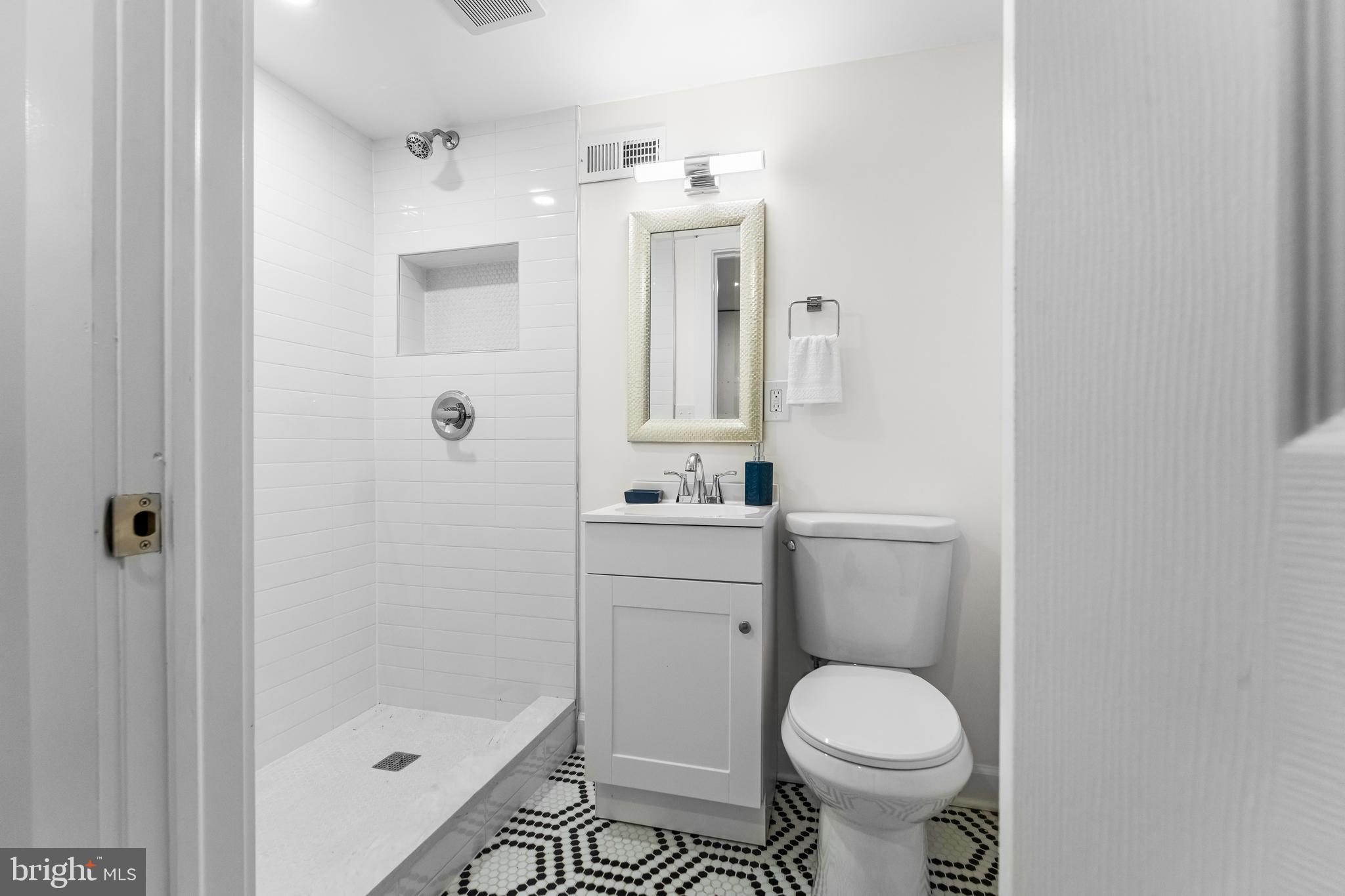 1003 West Fayette Street Baltimore, MD 21223 - Photo 58 of 59 a bathroom with a sink toilet and shower