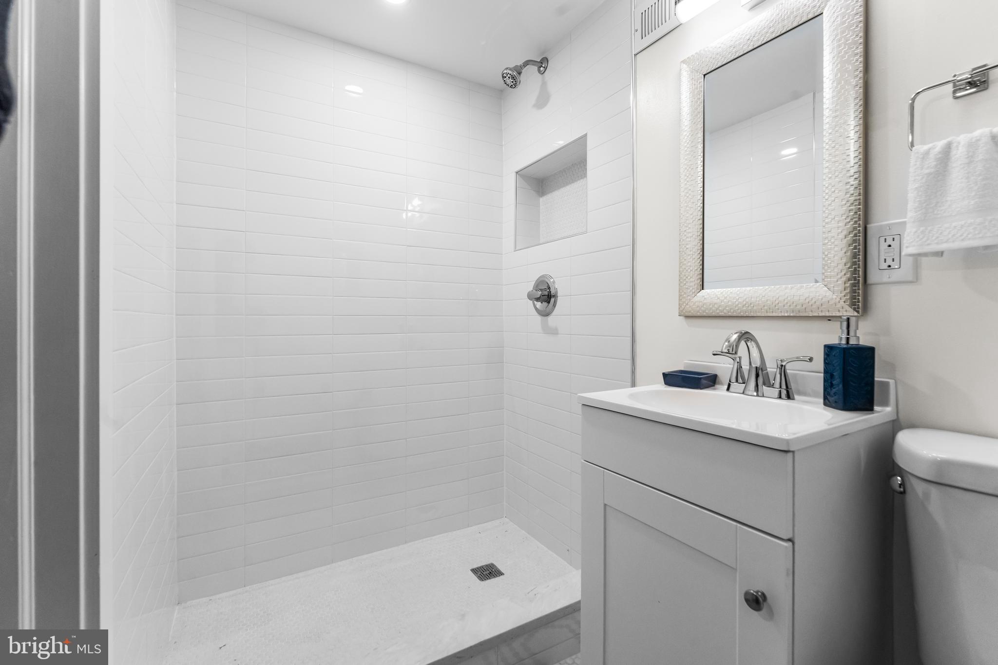 1003 West Fayette Street Baltimore, MD 21223 - Photo 59 of 59 a bathroom with a granite countertop sink a toilet and shower