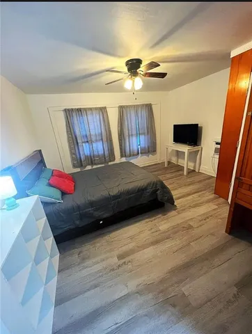 a bedroom with a bed and a mirror