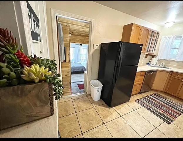 a kitchen with a refrigerator and a stove