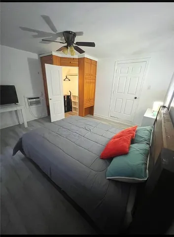 a bedroom with a bed and a mirror