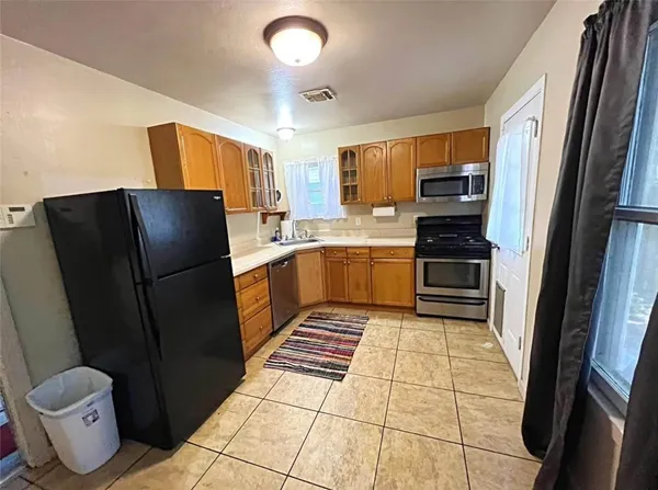 a kitchen with a refrigerator sink and stove