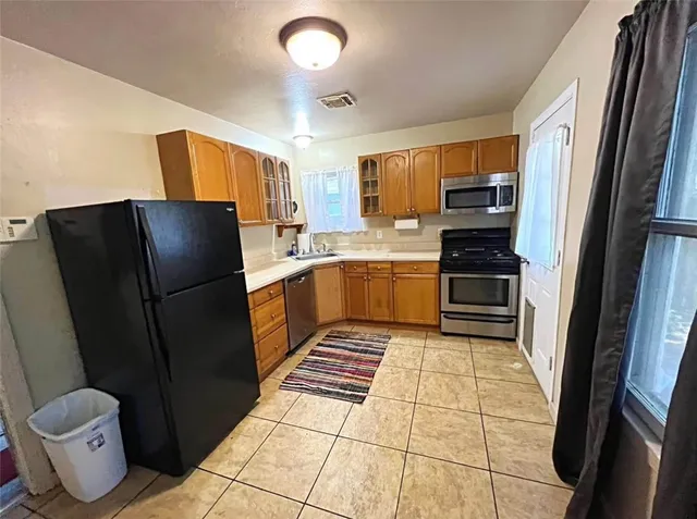 a kitchen with a refrigerator sink and stove